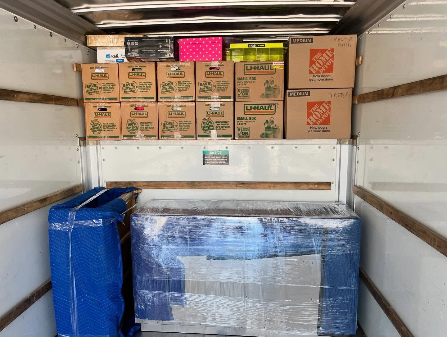 Husky Haulers mover carefully wrapping and protecting furniture before loading